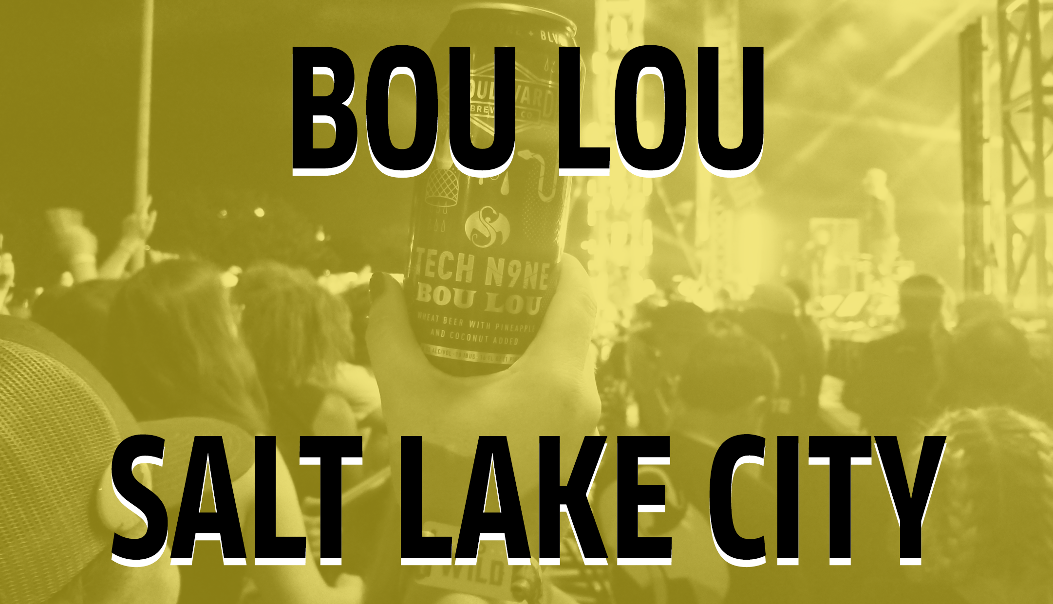 A person holds up a can labeled "Bou Lou" at a concert in Salt Lake City, with a yellow tint covering the image. The stage is visible in the background.