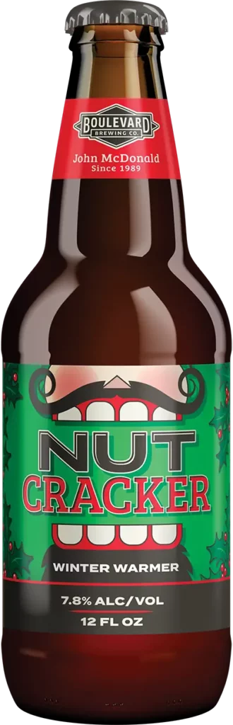 A bottle of Boulevard Brewing Co.'s Nut Cracker Winter Warmer beer. The label features festive red and green colors with holly decorations, and states the alcohol content as 7.8% by volume. The bottle is 12 fluid ounces.