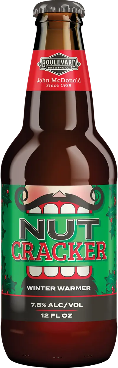 A bottle of Boulevard Brewing Co.'s Nut Cracker Winter Warmer beer. The label features festive red and green colors with holly decorations, and states the alcohol content as 7.8% by volume. The bottle is 12 fluid ounces.