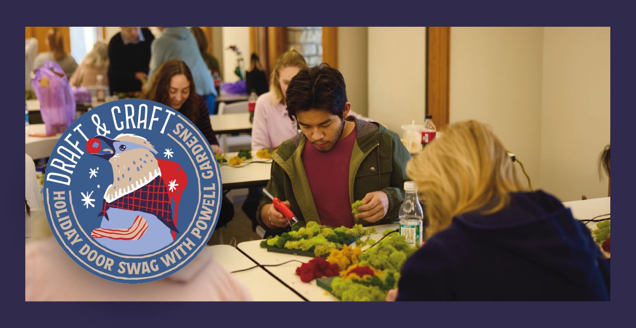 People gather at tables, immersed in crafting with greenery. A circular logo reads "Draft & Craft, Gardens, Holiday Door Swag with Powell," adorned with festive icons. The scene captures the essence of creativity and community at Draft & Craft events.